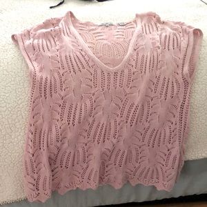 Pink crocheted top.